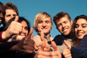 Group of People in their 20s with thumbs up