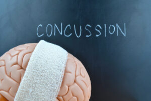 Brain Injury Awareness Month - brain with head wrap and concussion