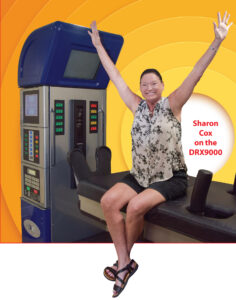 Sharon sitting on the RX9000 with hands raised